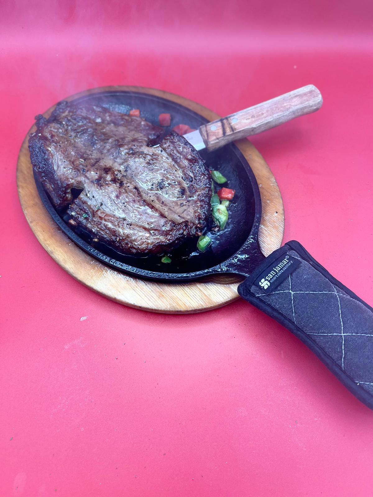 A steak on a pan.