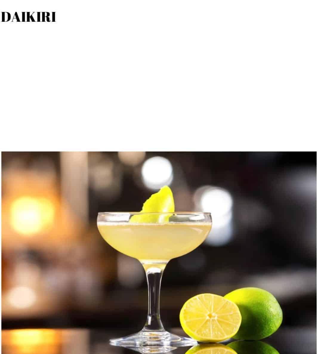 A martini glass with lime wedges in it.