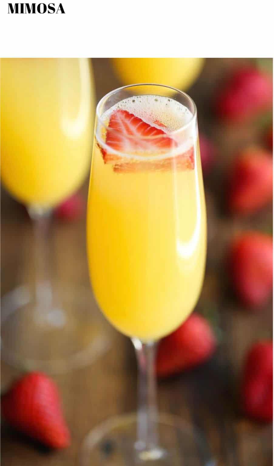 A glass of orange juice with strawberries in it.